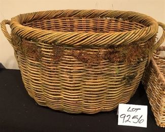 Lot 9256.  $38.00.  Two Antique or vintage baskets:  Oval basket with moss (26.5" W x 18" Deep x 13.5"H), and a rectangular rattan basket (15"L x 9.5"W x 7.5"H)