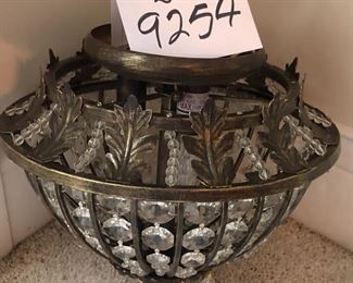 Lot 9254.  $50.00.  Lights of Distinction Classical crystal ceiling light.  Fixture has 3 lights, gold/black colors and antique brass accents. Fixture is 12" Diam and one foot tall!  Really stunning