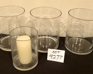 Lot 9277.  $50.00.  3 - 10"H x 8 diam glass vases/pillar candle holders and 1 vase with candle that is 6" x 8".