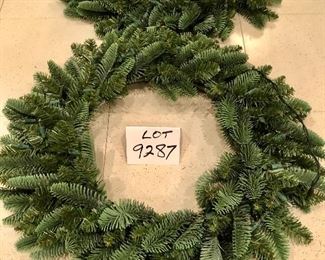 Lot 9287.  $40.00.  Two - 23" diameter lighted, green Christmas wreaths.