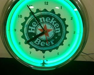Lot 9291.  $145.00.  Heineken patio table umbrella and a Heineken logo clock.  The perfect addition to your Man Cave or Bar & Rec Room!  The Heineken on ice is up to you.  Enjoy.