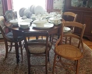 Round walnut table with 3 leaves and rack, set 6 cane bottom chairs,   White w/gold china priced individually