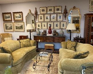 Pair of kidney shape sofas upholstered in chenille fabric. Beautiful brass and iron cocktail table. Multiple antique prints, Stunning mirrors, Pair of chinoiserie floor lamps.