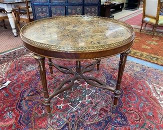 Maitland-Smith parcel gilt marble top foyer table with brass gallery on turned and tapered fluted legs.