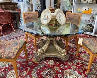 Stunning round foyer or dining glass top table with dolphin supports.