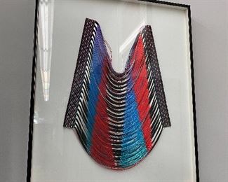 Framed handmade tribal breastplate.