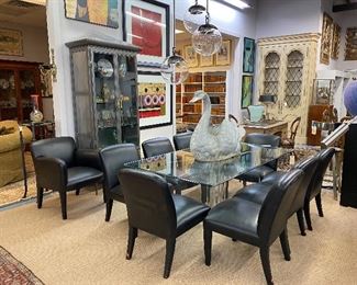 Set of eight Donghia black leather dining chairs. 
Donghia leather Armchair  that surround a Karl Springer glass top dining table with Lucite supports.