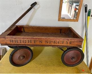 Antique wood wagon with advertising made by Monarch stamping Detroit Michigan.