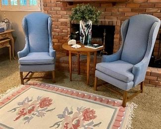 Narrow wingback chairs and flat weave rug.