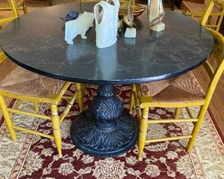 Cast iron pedestal table base with faux marble top and table pad.