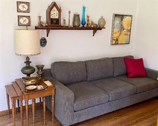 Handsome neutral grey sofa and one of two sets of stacking tables.