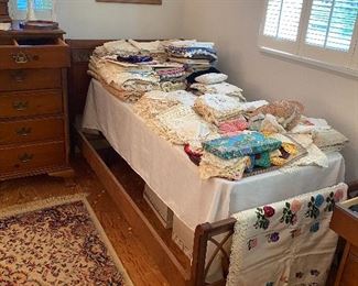 Another twin bed full of vintage lace and linens.