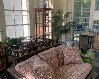 Wicker settee, faux foliage, urns, planters, topiary