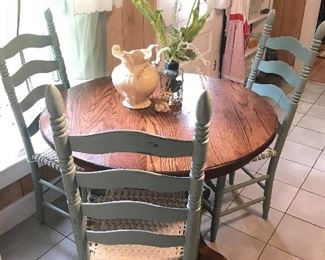 Small 30” round pedestal table with three ladder back chairs