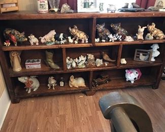 Six foot long handcrafted wood shelf with a lot of piggies