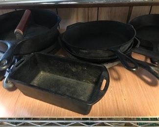 Collection of iron skillets and bakeware including Lodge