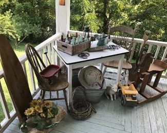 Vintage enamel top table, antique iron board, wash tub, wood rocking horse,  old cola wooden caddy and more rustic stuff. 