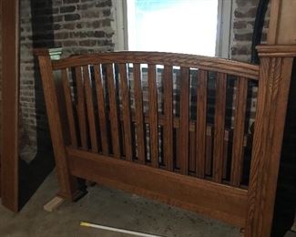Nice queen bed with headboard and footboard with wood rails. 