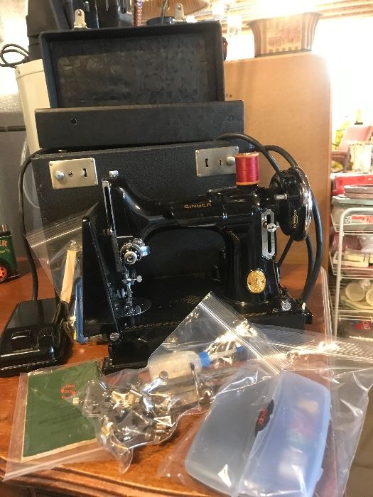 1941 Feather weight singer sewing machine with all the accessories-carrying box, instruction booklet, feet, bobbins etc...Excellent condition!