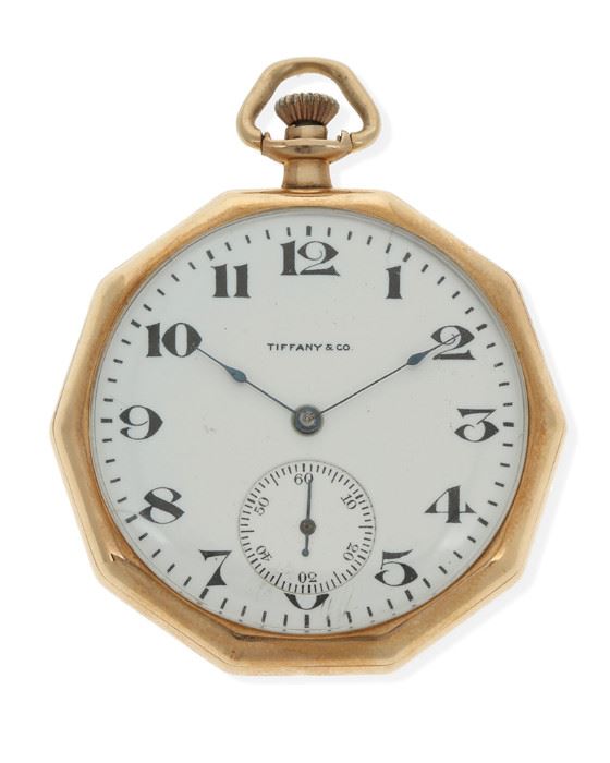 1001
A Gold Pocket Watch, Tiffany & Co
Dial: White circular dial with black Arabic numerals, sub-seconds dial, signed Tiffany & Co.
Movement:19J stemwind and set movement, jeweled gold chatons, nickel plated, damascened design, cut bi-metallic compensation balance, blued steel balance spring, jeweled straightline lever escapement, micrometric regulator, signed: Waltham / Mass. / Riverside, #23187356
Case: 14k yellow gold open face decagon shaped smooth polished case, signed: Wadsworth 14k Karat, #865767; with personalized engraved monogram
44 mm x 44 mm
59.3 grams
Estimate: $600 - $800