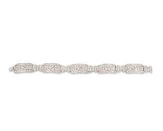 1004
A Diamond Bracelet
Circa 1945, platinum
Set with three hundred twenty single and full-cut round diamonds, totaling approximately 8cts and graded H-I color and VS-SI clarity
7.5" L x .5" W
29.7 grams
Estimate: $6,000 - $8,000