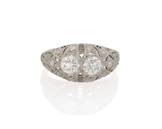 1003
An Art Deco Diamond Ring
Circa 1920, platinum
Centering two old European-cut diamonds, totaling approximately 1.2cts and graded E-F color and VS clarity
Ring size: 8
5 grams
Estimate: $2,500 - $3,500