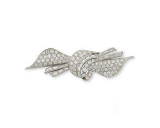 1008
A Diamond Bow Brooch
Circa 1950, platinum
Set with eighty-two single and full-cut round diamonds, totaling approximately 5.5cts and graded F-G color and VS clarity
2.5" W and .75" H
17 grams
Estimate: $3,000 - $4,000