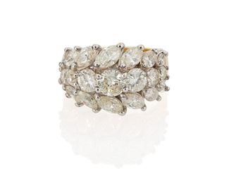 1018
A Diamond Ring
18k white and yellow gold
Set with six full-cut round diamonds and fourteen marquise-cut diamonds, totaling 4.23cts and graded H-J color and VS-SI clarity
Ring size: 7
9.8 grams
Estimate: $4,000 - $6,000
