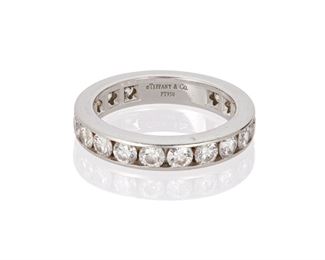 1020
A Tiffany & Co. Diamond Eternity Band
Platinum, stamped: (c) / Tiffany & Co. / Pt950
Designed with twenty channel-set full-cut round diamonds, totaling approximately 2cts and graded E-F color and VS clarity
Ring size: 6.5
6.2 grams
Estimate: $2,000 - $3,000