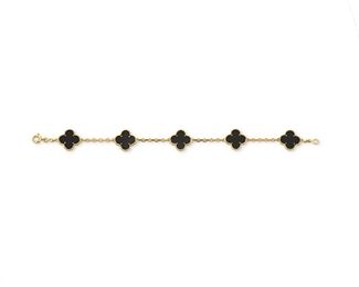 1030
A Van Cleef & Arpels "Alhambra" Onyx Bracelet
18k yellow gold, stamped: VCA / 750 / (c) / CF8944
Designed with five onyx quatrefoil panels within a beaded frame, with signed wooden box
7" x .25" W
10.7 grams
Estimate: $3,000 - $5,000