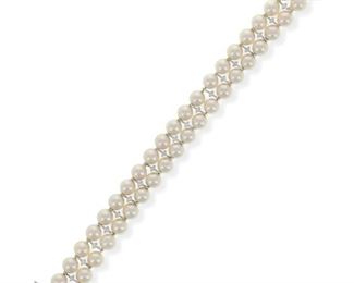 1087
A Mikimoto Cultured Pearl And Diamond Bracelet
18k white gold, design no. UD 7520 DA W 20, stamped: M [for Mikimoto] / 750
Designed with a double strand of cultured pearls measuring 7 mm, centering a line of twenty-one full-cut round diamonds, totaling approximately 1ct and graded F-G color and VS clarity,
7.5" L x .55" W
32 grams
Estimate: $800 - $1,200