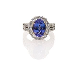 1088
A Tanzanite And Diamond Ring
18K white gold
Centering an oval-cut tanzanite, weighing 5.14cts, surrounded by thirty full-cut round diamonds, totaling approximately 2.8cts and graded G-H color and VS clarity
Ring size: 7
9.35 grams
Estimate: $3,500 - $4,500