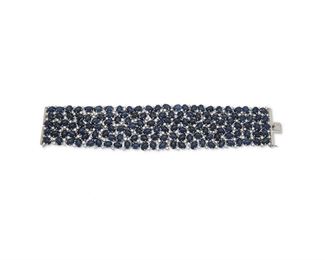 1114
A Wide Sapphire And Diamond Bracelet
18k white gold
The wide bracelet set with one hundred thirty-eight cabochon sapphires, weighing 199.2cts, and further set with two hundred fifty-six full-cut round diamonds, totaling 8.36cts
7.5" L x 2.5"
110 grams
Estimate: $15,000 - $20,000