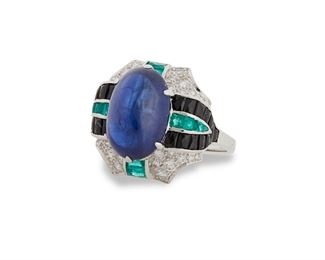 1115
A Sapphire And Gem-Set Ring
Platinum
Centering a cabochon sapphire, weighing 8cts, flanked by calibre-cut
onyx and emeralds, further embellished with full-cut round diamonds
Ring size: 7.75
8.4 grams
Estimate: $4,000 - $6,000
