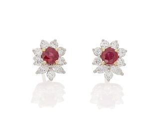 1130
A Pair Of Tiffany & Co. Ruby And Diamond Earrings
Platinum and 18k white gold, stamped: T & Co. Pt 950; Backings stamped: Tiffany & Co. / AU750
Set with two round rubies, totaling approximately .65ct., surrounded by two marquise and fourteen full-cut round diamonds, totaling approximately 1ct and graded E-F color and VS clarity, with signed blue suede box
.5" L
5 grams
2 pieces
Estimate: $7,000 - $9,000