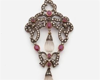 2015
A Ruby And Diamond Pendant
Silver and 14k yellow gold
Set with eight full-cut rubies, totaling approximately 2cts, further set with ninety full-cut round diamonds, totaling approximately 1ct and graded light brown color and SI clarity, suspending two carved rock crystal drops
3.4" L x 1.5" W
14.5 grams
Estimate: $300 - $500