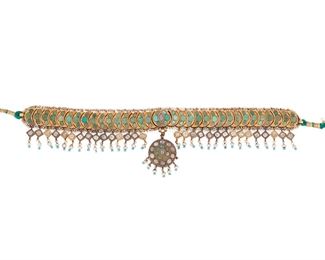 2018
An Indian Turquoise And Diamond Choker Necklace
Tests 18k yellow gold
Designed as crescent plaque inlaid with turquoise suspending a fringe of tablet-cut diamonds, the reverse bearing polished gold sunbursts, attached to a green colored cord
Central element: 7.5" L x 1.5" H
83 grams
Estimate: $2,500 - $3,500