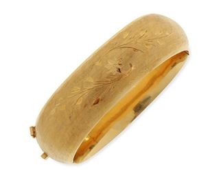 2044
A Gold Hinged Bangle Bracelet
18k yellow gold
Satin finished with floral engraving, bearing inside personalized inscription
7" C x .75" W
43.6 grams
Estimate: $1,200 - $1,800