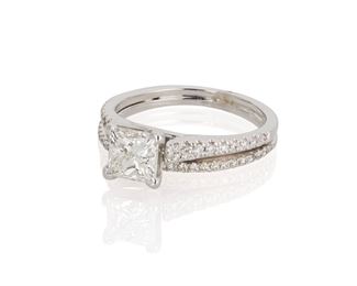 2087
A Diamond Ring
14k white gold
Twin joined rings centering a radiant-cut diamond, weighing .98ct and graded H-I color and SI clarity, flanked by small round diamonds
Ring size: 6
4 grams
Estimate: $1,000 - $1,500