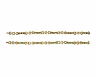 2117
A Pair Of Diamond And Gemstone Bracelets
18k yellow gold
Comprising an emerald and diamond bracelet and a sapphire and diamond bracelet
Each: 7" L
33.5 grams
2 pieces
Estimate: $2,000 - $3,000