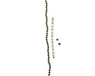 2165
A Group Of Gemstone Items
Comprising a 14k yellow gold and jadeite bracelet, a pair of unmounted star rubies totaling 13.68cts, and a nephrite bead necklace with metal clasp
Necklace: 17"
Bracelet: 14 grams
4 pieces
Estimate: $100 - $200