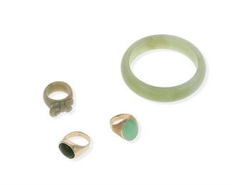 2168
A Group Of Jade Jewelry
Comprising a jade bangle (7.25" C x .75" W), a 14k yellow gold ring set with a cabochon jadeite measuring 20.5 mm x 14.5 mm x 5.5 mm (ring size: 9), a 14k yellow gold ring set with a cabochon nephrite measuring 15.5 mm x 12.5 mm x 4.7 mm (ring size: 9.75), and a carved jade pig ring (ring size: 10)
Two gold rings: 24 grams gross
4 pieces
Estimate: $600 - $800