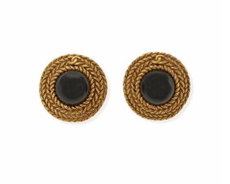 2193
A Pair Of Chanel Black Gripoix Ear Clips
Gold toned textured metal, stamped: [with double "C"] / Chanel / Made in France / (C)
The round ear clips centering black glass within a woven rope frame
1.25" W
2 pieces
Estimate: $400 - $600