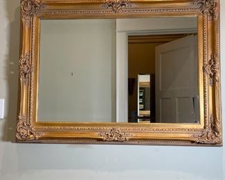 GILT FRAME MIRROR | Having a gilt scroll frame with beveled glass mirror insert, in excellent condition; overall 32-1/2 x 44-1/2 in. 