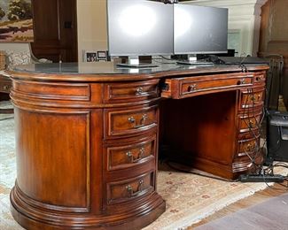 EXECUTIVE'S DESK | Seven Seas by Hooker Furniture, kidney form with a parquetry top, drawer keys and paperwork present, with a conforming protective glass top; h. 31 x w. 77 x d. 41 in. (approx.) 