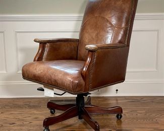 LEATHER DESK CHAIR | By Seven Seas Seating, executive's desk chair with brown leather upholstered seat and backrest, with faux alligator side and back upholstery with brass tacks throughout, on a wood base with casters, swivelling seat, adjustable; h. 44 x w. 28 x d. 35 in. 