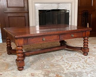 WOOD TRESTLE COFFEE TABLE | On turned legs, having two drawers on each long edge [with some surface scratches to top but appearing in overall very good condition]; h. 20-1/2 x w. 54 x d. 35-1/2 in. 