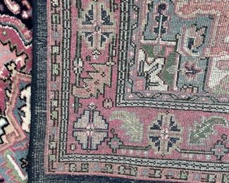 GEOMETRIC MEDALLION RUG | Pink medallion on a blue ground with a salmon border with rosettes and leaves [fringe worn, otherwise appears to be in good condition]; 9 ft. 2 in. x 5 ft. 5 in. 