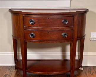 DEMILUNE SIDE TABLE | End table or nightstand, the top with a 3/4 gallery, with two drawers with nickel pulls; h. 30 x w. 36 x d. 17 in. 