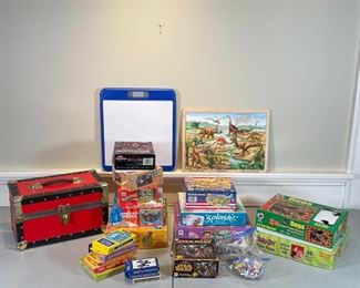GROUP PUZZLES & CARD GAMES | For young children, including a United States puzzle, Scooby Doo, Bugs puzzle, Star Wars, dinosaurs, card games, learning cards, decks of cards, etc.; plus a red and black small trunk with hinged clasping lid [note: puzzle pieces and cards not counted, unsure if complete] 